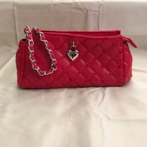 Very small red makeup bag. Victoria’s Secret.
